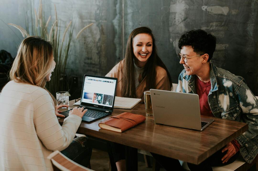 Happy office workers with Macs